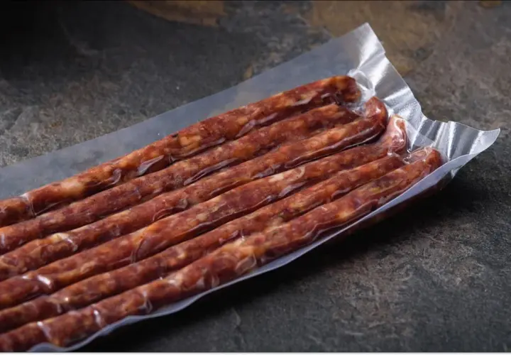 Pakowane próżniowo kiełbaski, idealne na podróż. Czy można przewieźć mięso w samolocie? Takie pakowanie może pomóc.