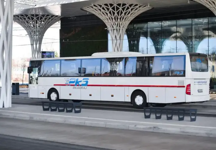 Autobus PKS Biłgoraj czeka na pasażerów przy nowoczesnej wiacie, gotowy do podróży z Krakowa do Katowice Airport.