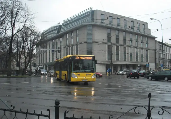 Żółty autobus 304 na skrzyżowaniu w Krakowie, jadący w kierunku Wieliczki. Sprawdź rozkład jazdy!