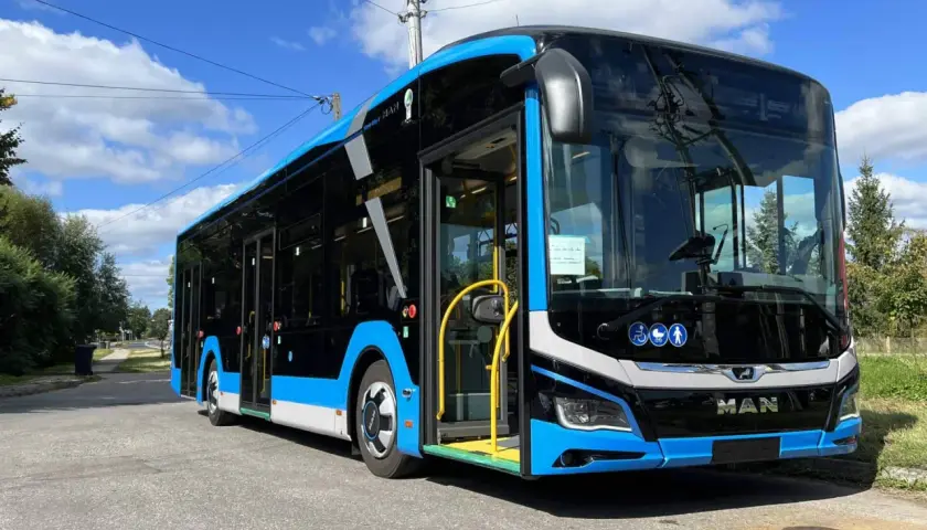 Nowy, niebiesko-czarny autobus MAN, gotowy do kursu Zamość-Kraków, stoi na ulicy.