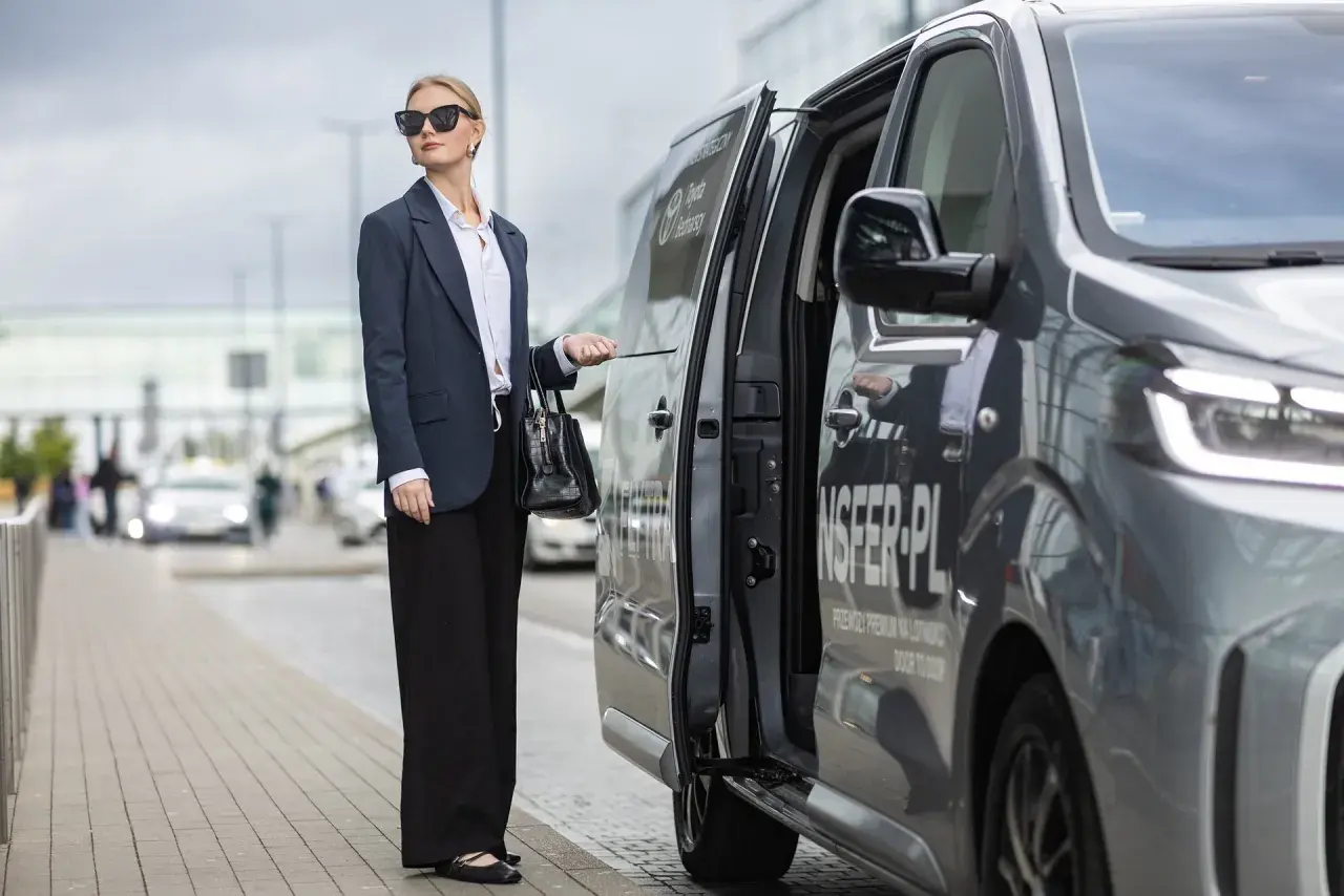 Elegancka kobieta czeka na transfer z Torunia na lotnisko Chopina w Warszawie.