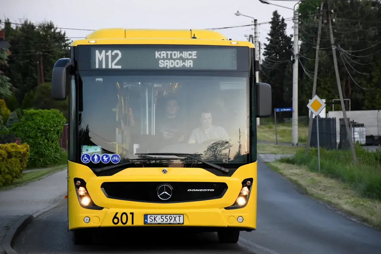 Żółty autobus linii M12 z napisem 